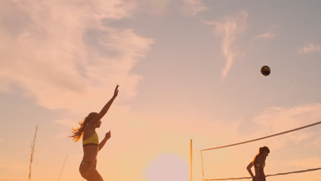 Beach-volleyball-serve---woman-serving-in-beach-volley-ball-game.-Overhand-spike-serve.-Young-people-having-fun-in-the-sun-living-healthy-active-sports-lifestyle-outdoors